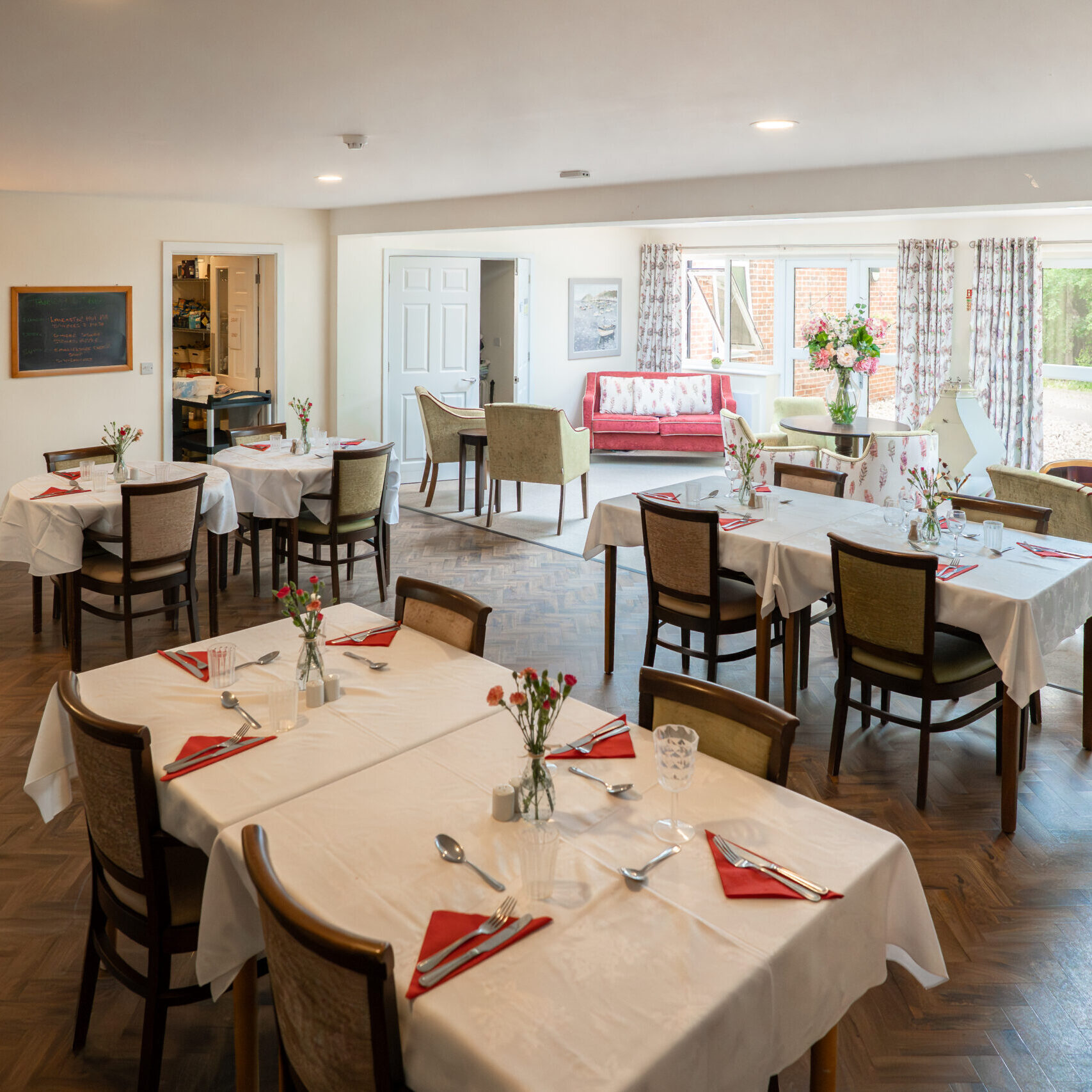 Dining room laid for a meal at Tudor Lodge