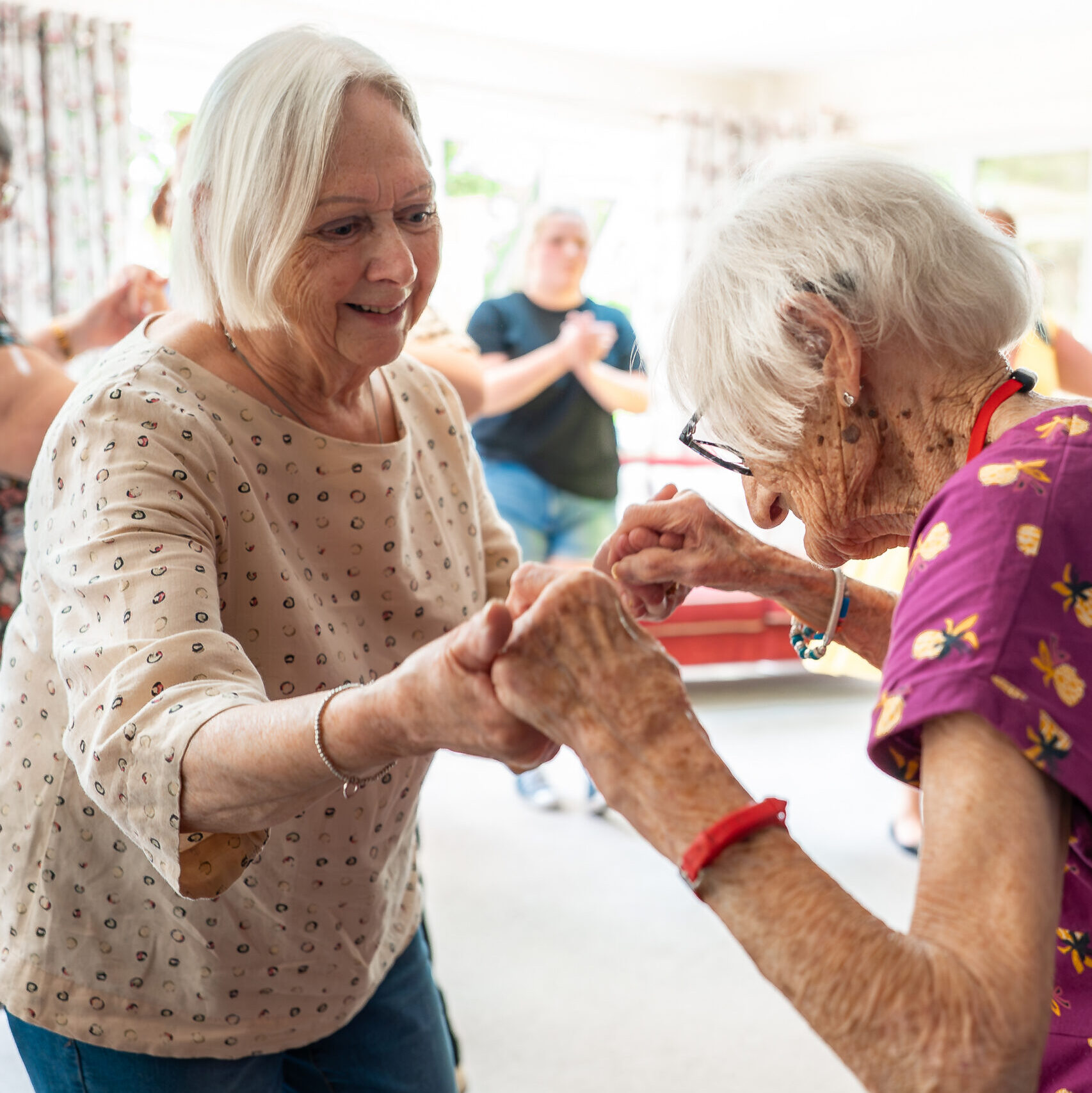 Two residents dancing together at Tudor Lodge