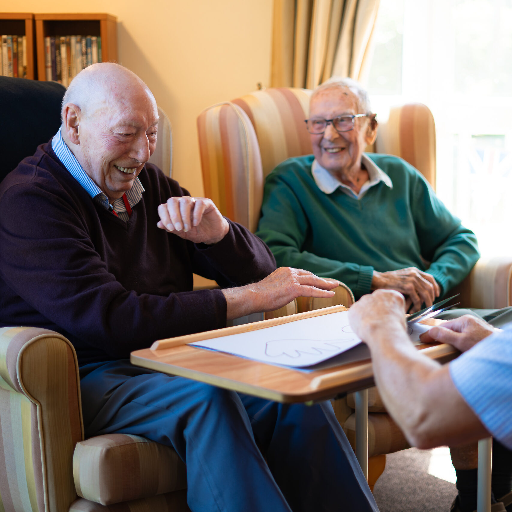 Two residents playing a game together at Canford Manor