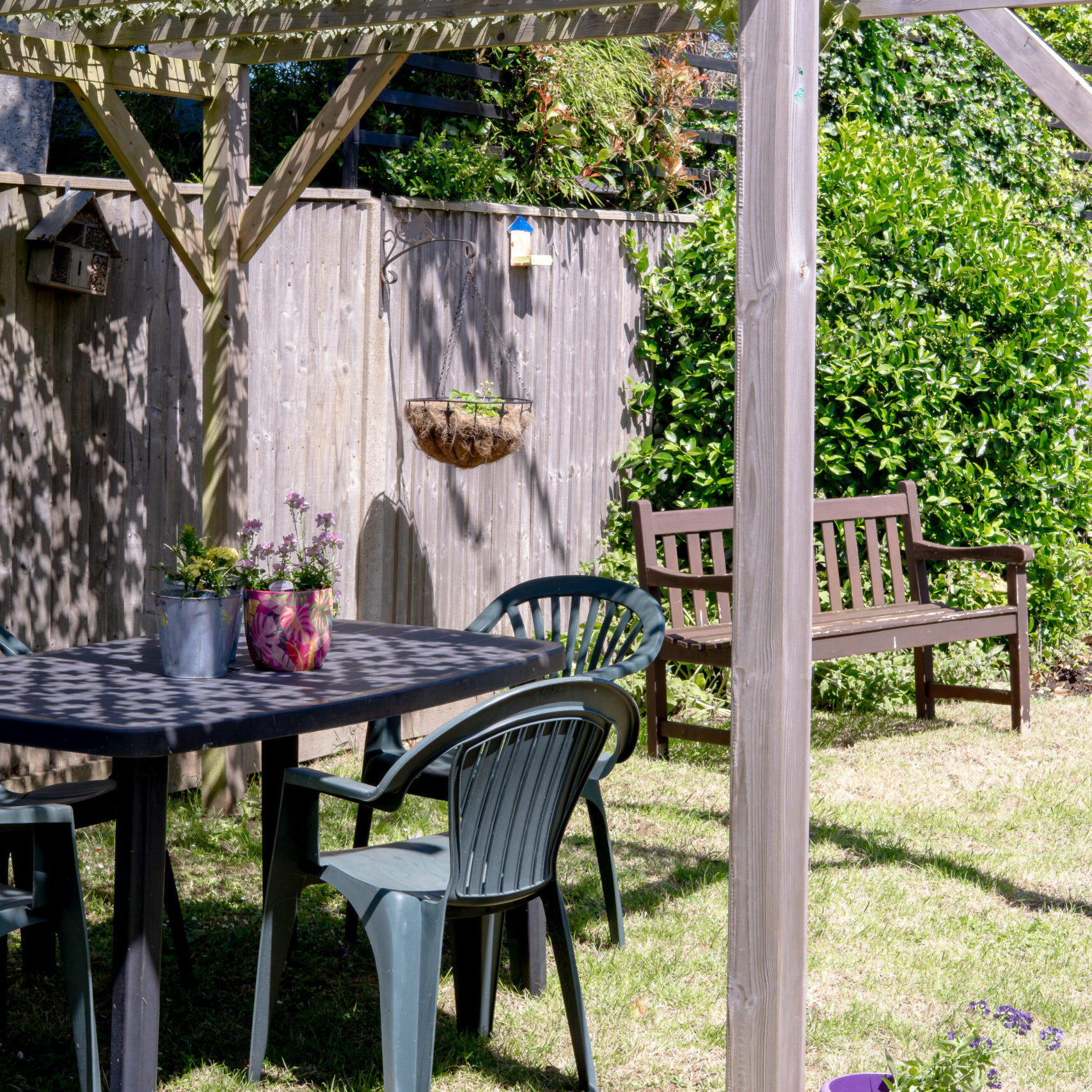 Garden patio with tables and chairs at Canford Manor