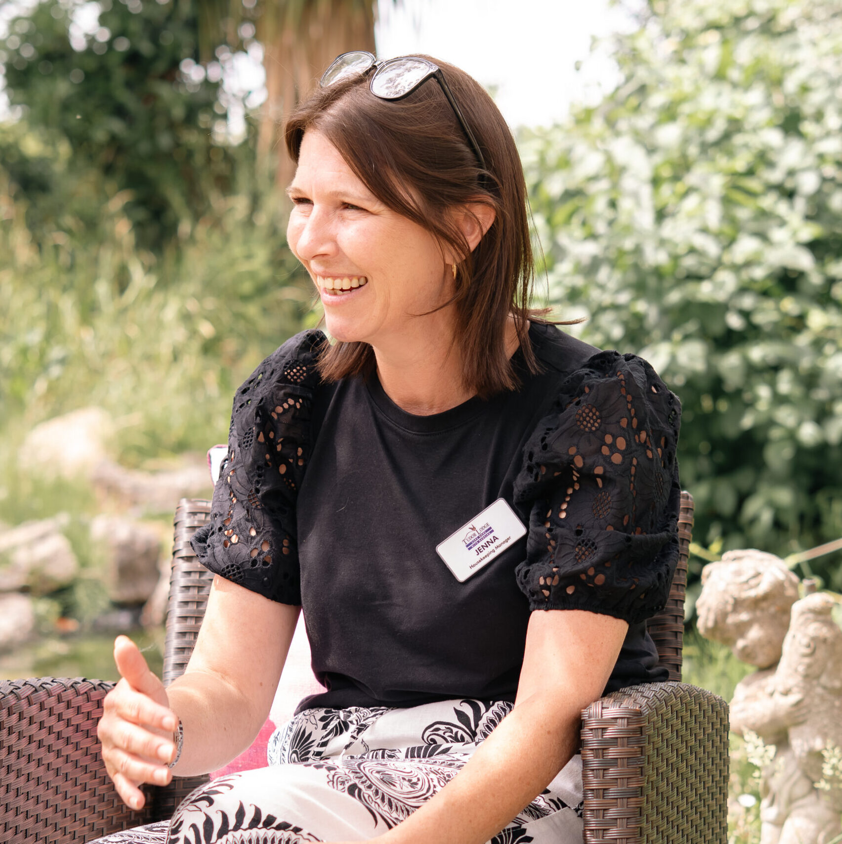 Smiling member of the Tudor Lodge team in the garden